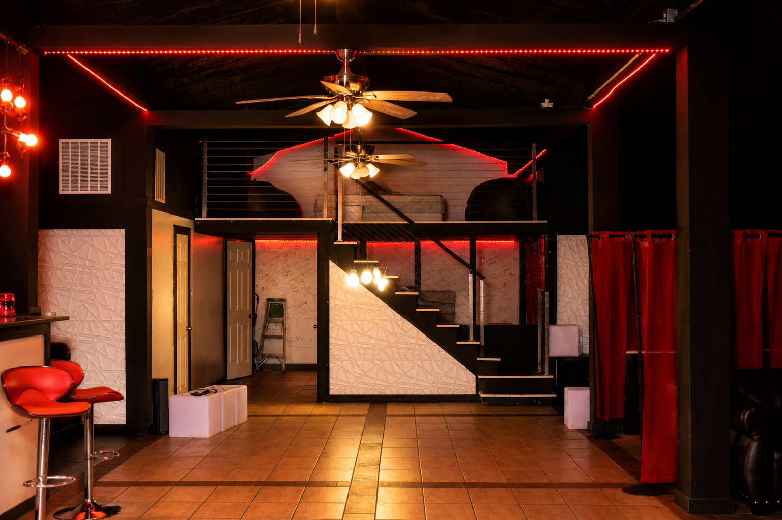 Thee Compound venue interior with red lighting and loft area